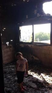Little girl in her room - in house destroyed by Jewish military